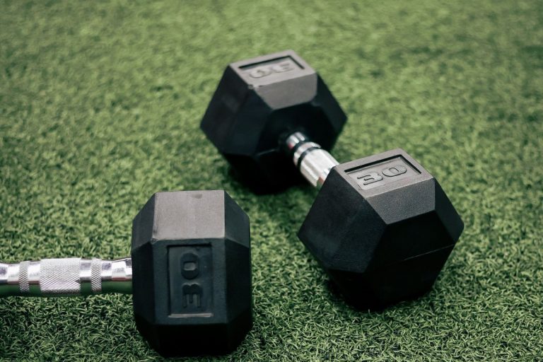 Rubber coated hex dumbbells on gym turf material comparison