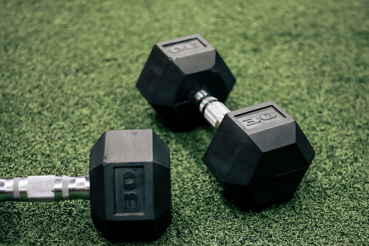 Rubber coated hex dumbbells on gym turf material comparison