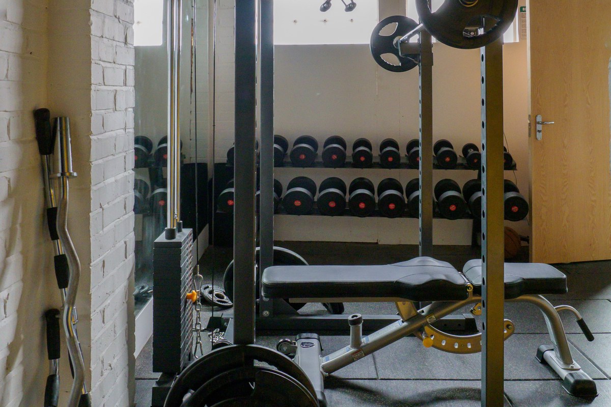 Home gym power rack with weight bench and barbell