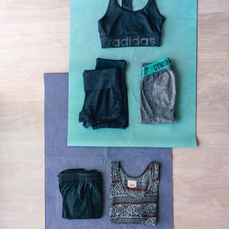 Flat lay of workout clothes and yoga mats, perfect for fitness inspiration.