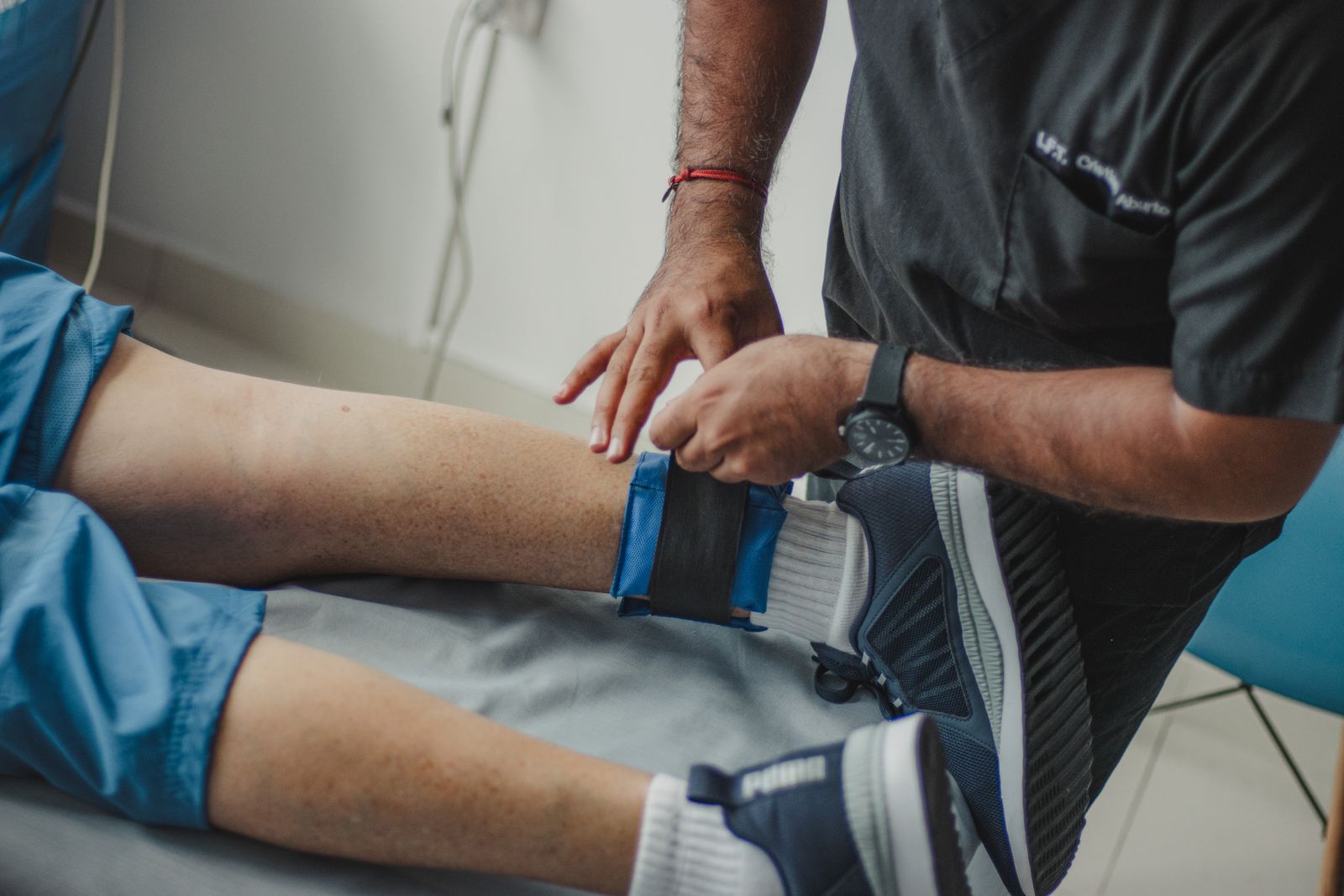 Physical therapist applying compression to a patient leg after injury