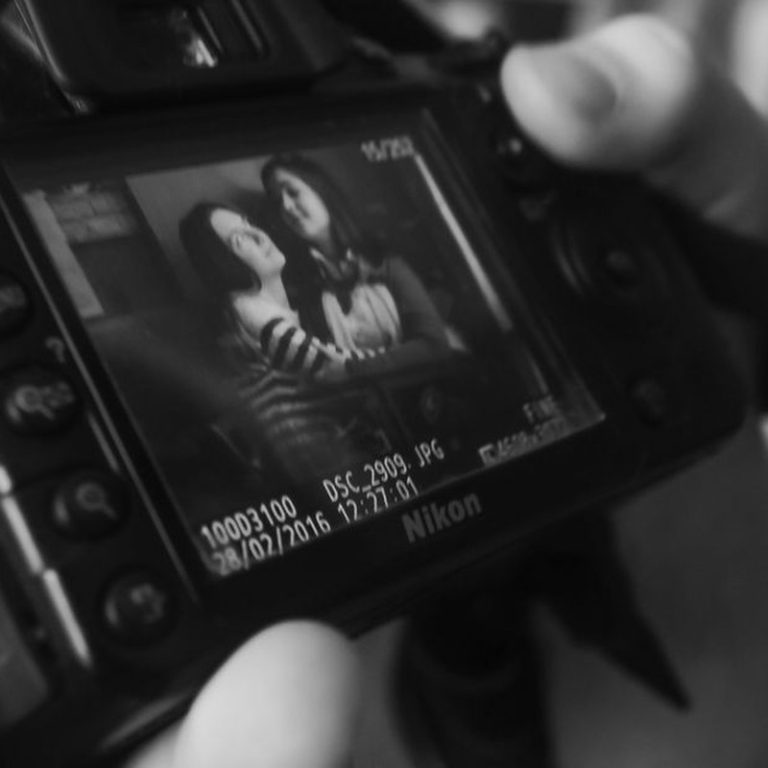 Monochrome image of a DSLR screen displaying a portrait, emphasizing photography.