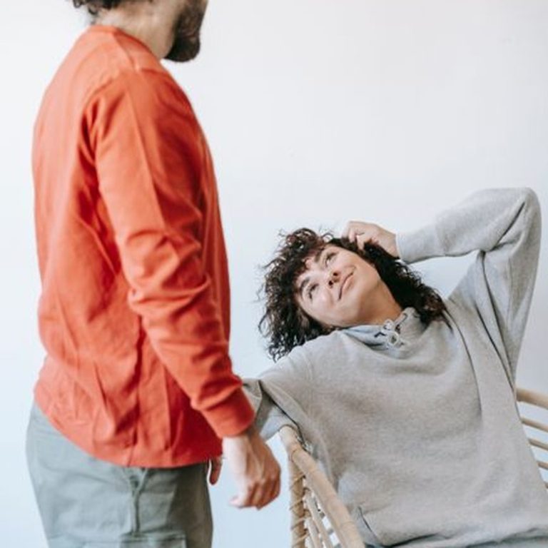 A couple in casual attire enjoying a relaxed moment indoors with warmth and togetherness.