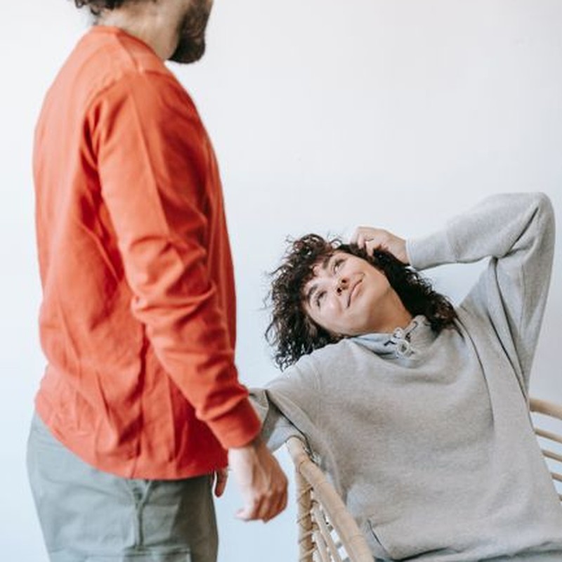 A couple in casual attire enjoying a relaxed moment indoors with warmth and togetherness.
