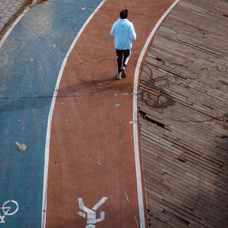Runner on a colorful urban track depicting active lifestyle and outdoor exercise.