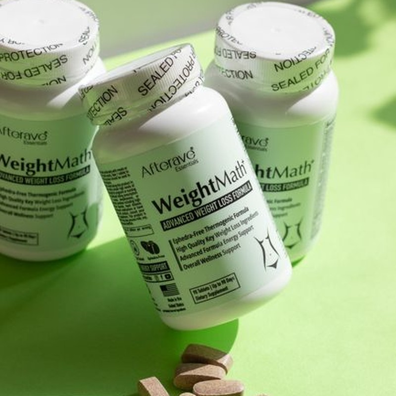 Three bottles of weight loss supplements with tablets on a green surface.