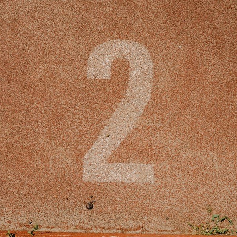 Close-up of number two on a track starting line, perfect for sports themes.