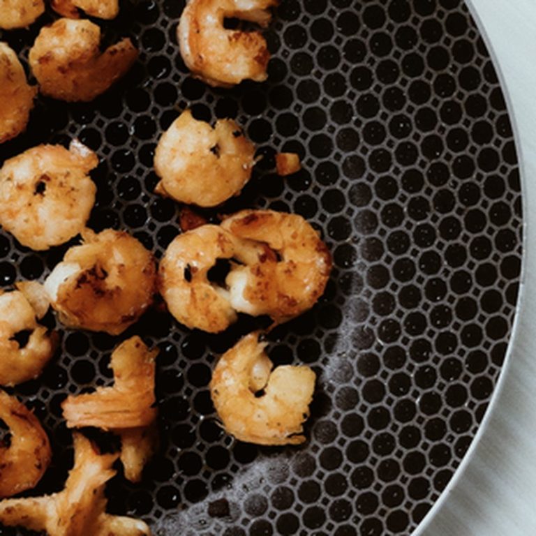 Deliciously fried shrimps on a round plate, perfect for seafood enthusiasts.