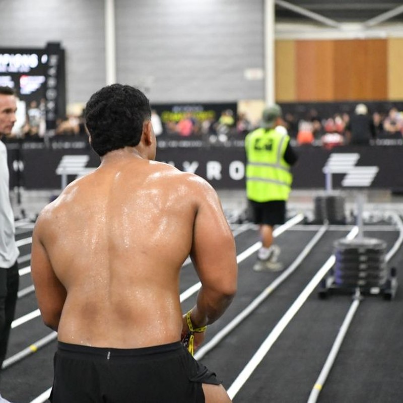 Athlete preparing for intense fitness challenge indoors at a competitive event in Singapore.