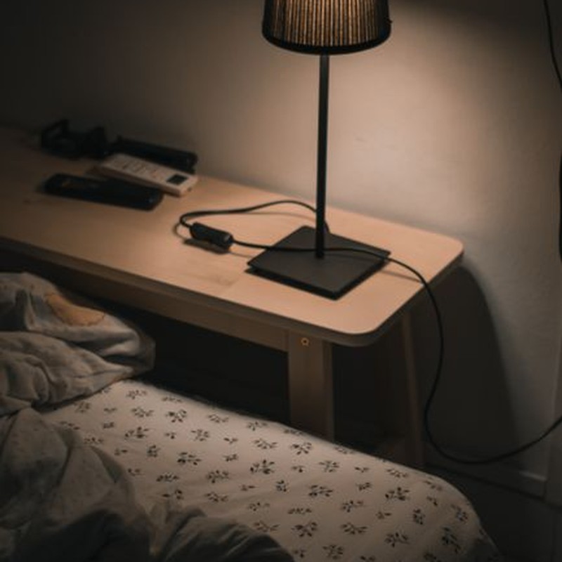 Warm ambiance in a cozy bedroom featuring a bedside lamp illuminating the night.
